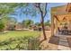 Large backyard with grassy area, patio, and built-in grill at 4113 E Burnside Trl, Cave Creek, AZ 85331