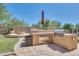 Outdoor kitchen with built-in grill and stone countertops at 4113 E Burnside Trl, Cave Creek, AZ 85331