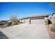 House exterior features a three-car garage and desert landscaping at 42028 N Crooked Stick Rd, Anthem, AZ 85086