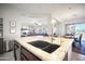 Kitchen island with double sink, granite countertops and views of the Gathering room at 42028 N Crooked Stick Rd, Anthem, AZ 85086