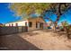 Backyard view of home with a large tree at 4249 S Pony Rider Trl, Gold Canyon, AZ 85118