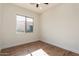 Simple bedroom with wood flooring and large window at 4249 S Pony Rider Trl, Gold Canyon, AZ 85118