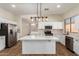 Bright kitchen featuring white cabinetry, an island, and wood-look flooring at 4249 S Pony Rider Trl, Gold Canyon, AZ 85118