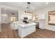 Open kitchen with white cabinets, island, and stainless steel appliances at 4249 S Pony Rider Trl, Gold Canyon, AZ 85118