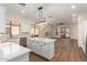 Modern kitchen with white cabinets, island, and hardwood floors at 4249 S Pony Rider Trl, Gold Canyon, AZ 85118