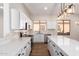 Modern kitchen with white cabinets, quartz countertops, and stainless steel appliances at 4249 S Pony Rider Trl, Gold Canyon, AZ 85118