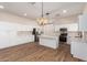 Modern kitchen with white cabinets, island, and hardwood floors at 4249 S Pony Rider Trl, Gold Canyon, AZ 85118