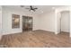 Living room with hardwood floors, sliding door to backyard, and a ceiling fan at 4249 S Pony Rider Trl, Gold Canyon, AZ 85118