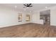 Bright living room with hardwood floors and ceiling fan at 4249 S Pony Rider Trl, Gold Canyon, AZ 85118