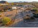 Aerial view showing a long driveway leading to a ranch-style home at 49651 W Dune Shadow Rd, Maricopa, AZ 85139