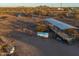 Aerial view of the ranch showing additional stables and covered seating at 49651 W Dune Shadow Rd, Maricopa, AZ 85139