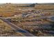 Aerial view of a property with several buildings and a large fenced area at 49651 W Dune Shadow Rd, Maricopa, AZ 85139