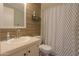 Modern bathroom with wood-paneled walls and updated shower at 49651 W Dune Shadow Rd, Maricopa, AZ 85139