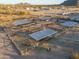 Aerial view of several horse stalls with shade coverings at 49651 W Dune Shadow Rd, Maricopa, AZ 85139