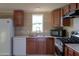 Modern kitchen with wood cabinets and stainless steel appliances at 49651 W Dune Shadow Rd, Maricopa, AZ 85139