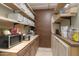 Well-organized pantry with ample shelving and counter space for storage at 49651 W Dune Shadow Rd, Maricopa, AZ 85139