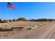 Front yard with American flag and desert landscape at 49651 W Dune Shadow Rd, Maricopa, AZ 85139