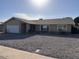 Single-story house with a large front yard and a two-car garage at 5215 W Acapulco W Ln, Glendale, AZ 85306