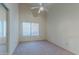 Simple bedroom with window, ceiling fan and neutral carpeting at 5335 W Bloomfield Rd, Glendale, AZ 85304