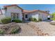 White stucco home with tile roof, landscaping, and a two-car garage at 5335 W Bloomfield Rd, Glendale, AZ 85304