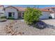 Single-story home with a two-car garage, desert landscaping, and a welcoming front entrance at 5335 W Bloomfield Rd, Glendale, AZ 85304