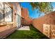 Private backyard with artificial turf, patio, and a tall wall for privacy at 5640 E Bell Rd # 1101, Scottsdale, AZ 85254