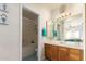 Bathroom features a soaking tub, wood vanity, and a mirrored medicine cabinet at 5640 E Bell Rd # 1101, Scottsdale, AZ 85254