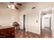 Bedroom with wood desk, double closet, and access to hallway bath at 5640 E Bell Rd # 1101, Scottsdale, AZ 85254