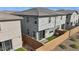 Backyard view of a gray two-story home with a sliding glass door, small grassy area, and block wall at 5819 E Rose Garden Ln, Phoenix, AZ 85054