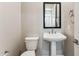 Bathroom with pedestal sink and toilet at 5819 E Rose Garden Ln, Phoenix, AZ 85054