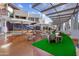 Outdoor seating area with modern umbrellas and a large screen at 5819 E Rose Garden Ln, Phoenix, AZ 85054