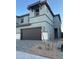 Two-story modern home with gray siding, attached garage, and landscaped front yard at 5819 E Rose Garden Ln, Phoenix, AZ 85054