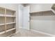 Large walk-in closet with built-in shelves and hanging rod at 5819 E Rose Garden Ln, Phoenix, AZ 85054