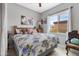 Bedroom with floral bedding, window, and dresser at 5830 E Fox Hollow Ln, San Tan Valley, AZ 85140