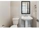 Powder room with pedestal sink and modern fixtures at 5846 E Ringtail Way, Phoenix, AZ 85054