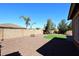 Landscaped backyard with artificial turf and trees at 6830 S Crystal Way, Chandler, AZ 85249