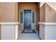 Elegant front door entry with decorative metal design and welcome mat at 6830 S Crystal Way, Chandler, AZ 85249