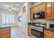 Kitchen with stainless steel appliances and wood cabinetry at 6830 S Crystal Way, Chandler, AZ 85249