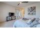 Main bedroom with ceiling fan and large TV at 6830 S Crystal Way, Chandler, AZ 85249