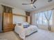 Spacious bedroom with built-in wood cabinets and large windows at 6830 S Crystal Way, Chandler, AZ 85249