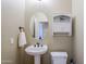 Small powder room with pedestal sink and storage at 6830 S Crystal Way, Chandler, AZ 85249