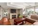 Living room with fireplace, hardwood floors, and brown leather sectional at 7167 E Rancho Vista Dr # 4011, Scottsdale, AZ 85251