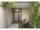 Modern entryway with a covered walkway and potted plants at 7760 E Gainey Ranch Rd # 18, Scottsdale, AZ 85258