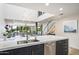 Modern kitchen island with double sink and stainless steel appliances at 7760 E Gainey Ranch Rd # 18, Scottsdale, AZ 85258