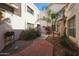 Inviting courtyard entry with lush landscaping and a tranquil fountain at 7800 E Lincoln Dr # 1029, Scottsdale, AZ 85250