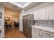 Kitchen boasts stainless steel refrigerator and white cabinets at 7800 E Lincoln Dr # 1029, Scottsdale, AZ 85250