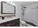 Updated bathroom with dark vanity and hexagon tile shower at 8014 E Oak St, Scottsdale, AZ 85257