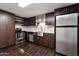 Modern kitchen with stainless steel appliances and dark cabinets at 8014 E Oak St, Scottsdale, AZ 85257