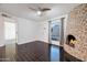 Living room with fireplace, dark hardwood floors, and ceiling fan at 8014 E Oak St, Scottsdale, AZ 85257