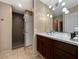 Modern bathroom with a large shower and a vanity with marble countertop at 9223 E Whitethorn Cir # 667, Scottsdale, AZ 85266